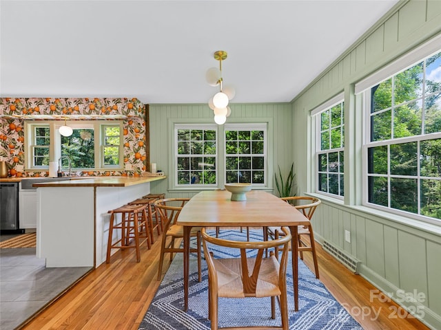 90 W Skyland Cir Unit 1, Asheville, NC 28804 - dining area with light wood finished floors and a decorative wall