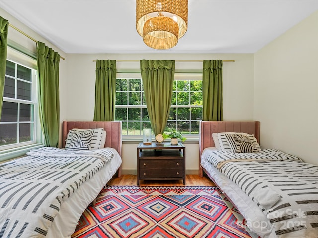 90 W Skyland Cir Unit 1, Asheville, NC 28804 - bedroom with a chandelier and wood finished floors