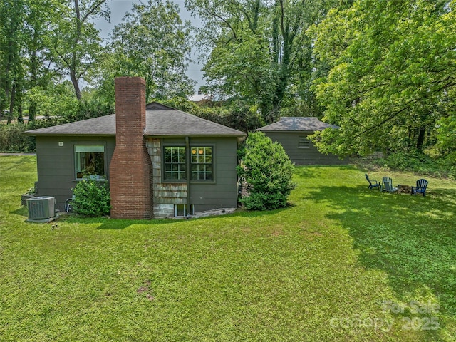 90 W Skyland Cir Unit 1, Asheville, NC 28804 - back of house with a chimney, a yard, cooling unit, and a shingled roof