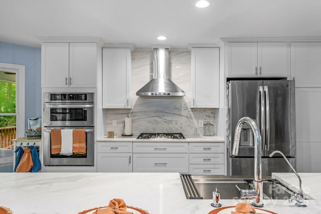 5317 Black Oak Ln Unit 11, Waxhaw, NC 28173 - kitchen with stainless steel appliances, wall chimney range hood, decorative backsplash, white cabinetry, and recessed lighting