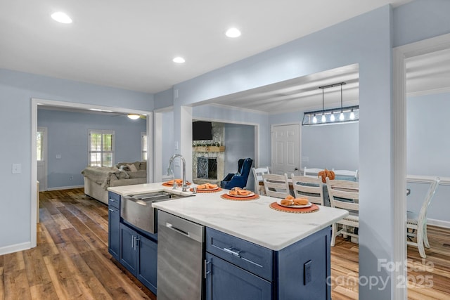 5317 Black Oak Ln Unit 11, Waxhaw, NC 28173 - kitchen with open floor plan, blue cabinetry, a sink, dark wood-style flooring, and a kitchen island with sink