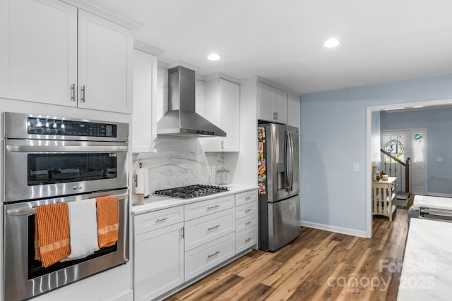 5317 Black Oak Ln Unit 11, Waxhaw, NC 28173 - kitchen featuring appliances with stainless steel finishes, wall chimney exhaust hood, light countertops, wood finished floors, and recessed lighting