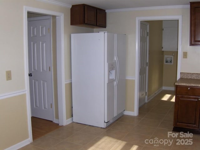 134 Crystal Cir, Mooresville, NC 28117 - kitchen featuring white refrigerator with ice dispenser, light tile patterned floors, baseboards, and crown molding