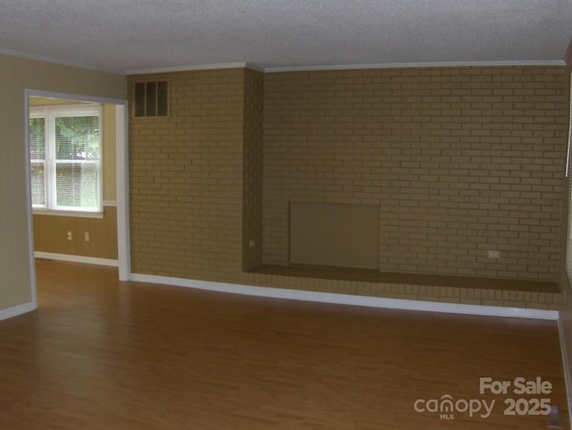 134 Crystal Cir, Mooresville, NC 28117 - empty room with ornamental molding, wood finished floors, baseboards, and a textured ceiling