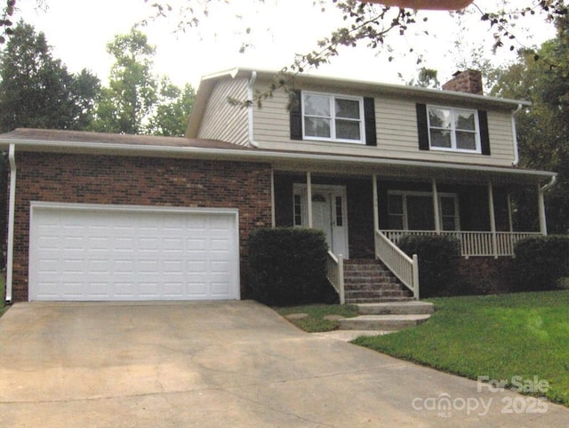 134 Crystal Cir, Mooresville, NC 28117 - view of front facade with driveway, a chimney, brick siding, a porch, and an attached garage