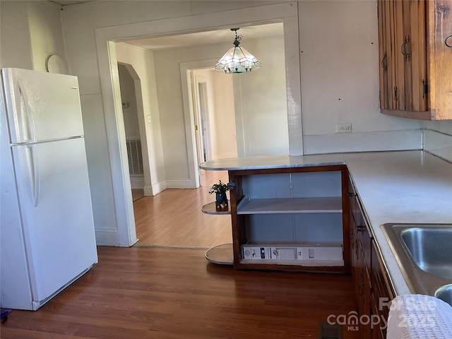 2138 SW Haven Cir, Lenoir, NC 28645 - kitchen featuring freestanding refrigerator, wood finished floors, light countertops, a chandelier, and baseboards