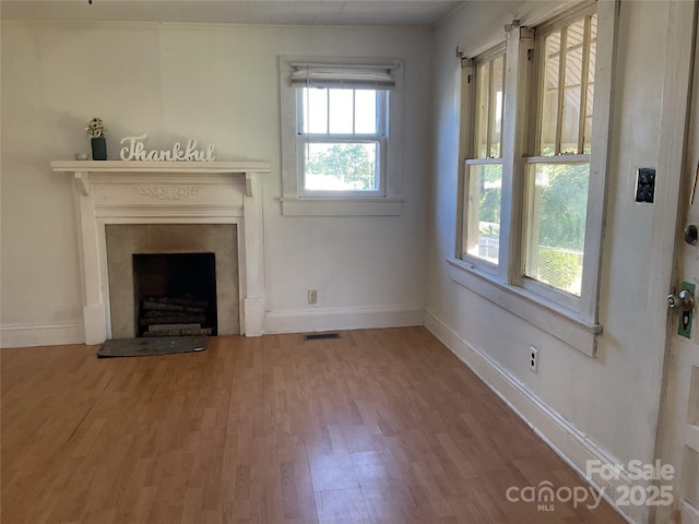 2138 SW Haven Cir, Lenoir, NC 28645 - unfurnished living room featuring wood finished floors, baseboards, and a fireplace