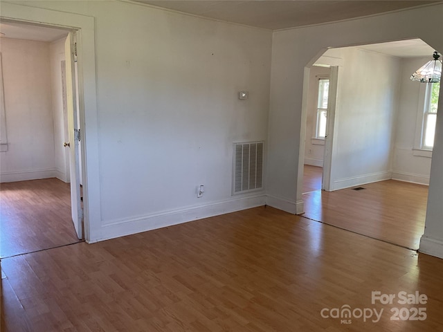 2138 SW Haven Cir, Lenoir, NC 28645 - spare room featuring arched walkways, wood finished floors, and baseboards
