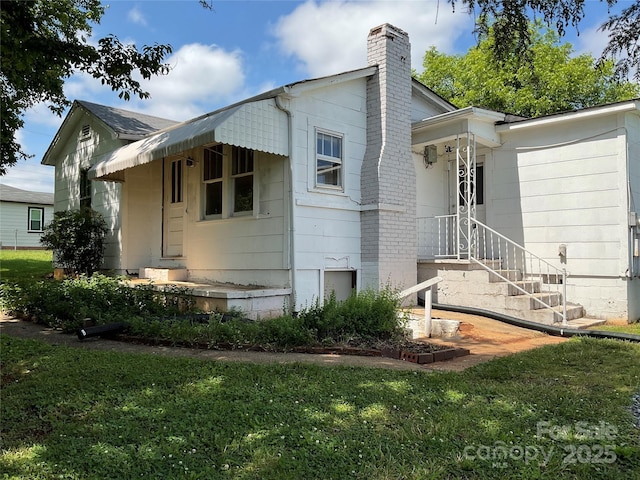 2138 SW Haven Cir, Lenoir, NC 28645 - view of home's exterior featuring a chimney and a yard