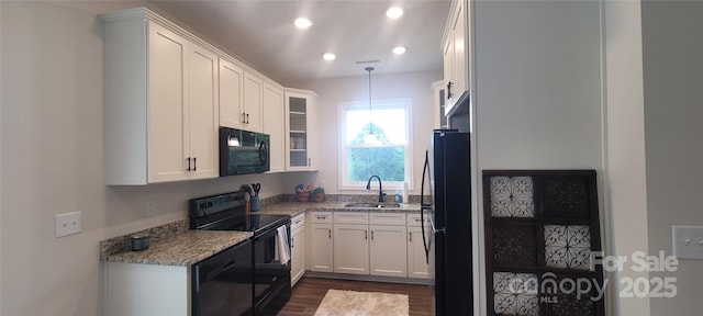 132 Connestee Rd, Brevard, NC 28712 - kitchen with black appliances, a sink, white cabinets, dark wood finished floors, and light stone counters