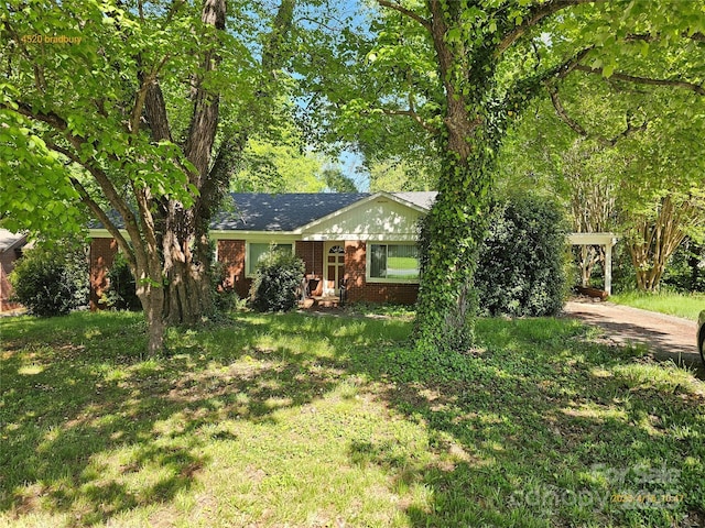 4520 Bradbury Dr, Charlotte, NC 28209 - view of front of property with brick siding, a carport, a front yard, and driveway