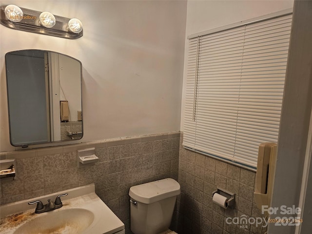 4520 Bradbury Dr, Charlotte, NC 28209 - bathroom with toilet, vanity, tile walls, and a wainscoted wall