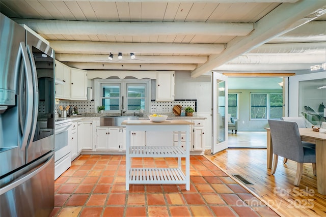 15 Wilson Way, Flat Rock, NC 28731 - kitchen with stainless steel refrigerator with ice dispenser, white electric range oven, tasteful backsplash, white cabinets, and light countertops