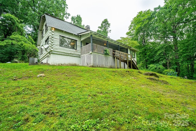 15 Wilson Way, Flat Rock, NC 28731 - back of property featuring a chimney, a deck, roof with shingles, log exterior, and a yard