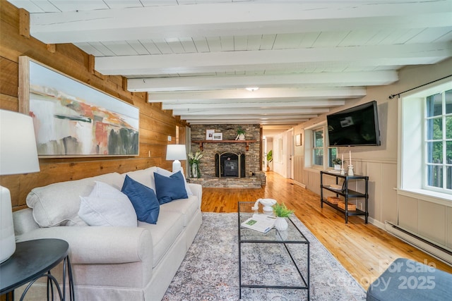 15 Wilson Way, Flat Rock, NC 28731 - living room featuring wood-type flooring, a baseboard radiator, wood walls, a large fireplace, and beam ceiling
