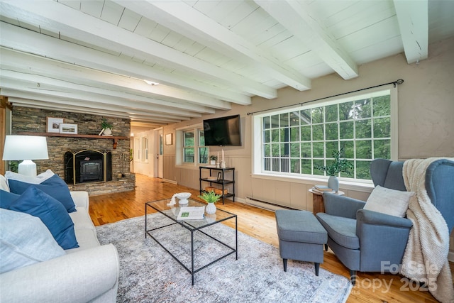 15 Wilson Way, Flat Rock, NC 28731 - living room with wood finished floors, a baseboard heating unit, beam ceiling, and a stone fireplace