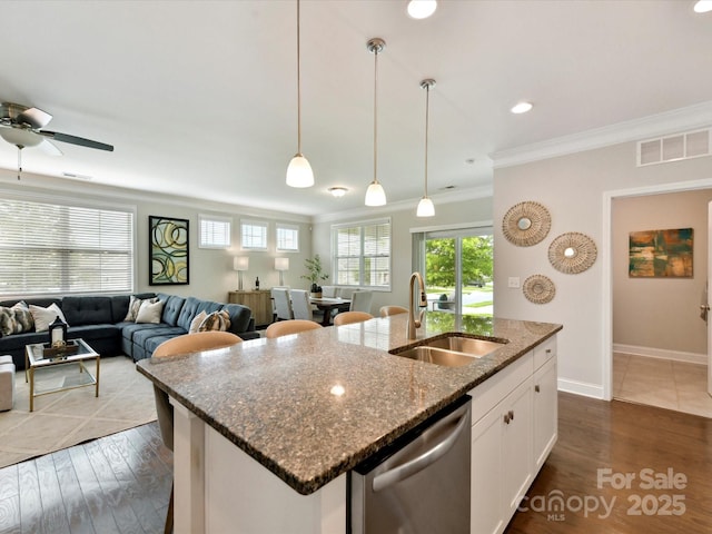 505 Belle Grove Dr, Lake Wylie, SC 29710 - kitchen with stainless steel dishwasher, a sink, crown molding, dark wood-style flooring, and a kitchen island with sink
