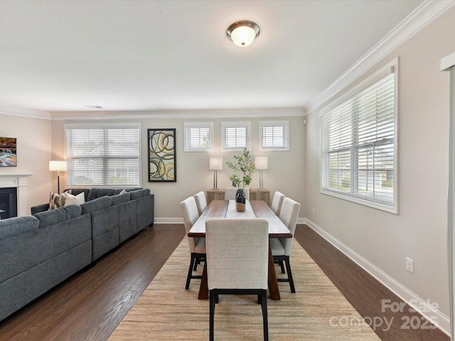 505 Belle Grove Dr, Lake Wylie, SC 29710 - dining area featuring crown molding, dark wood finished floors, baseboards, and a glass covered fireplace