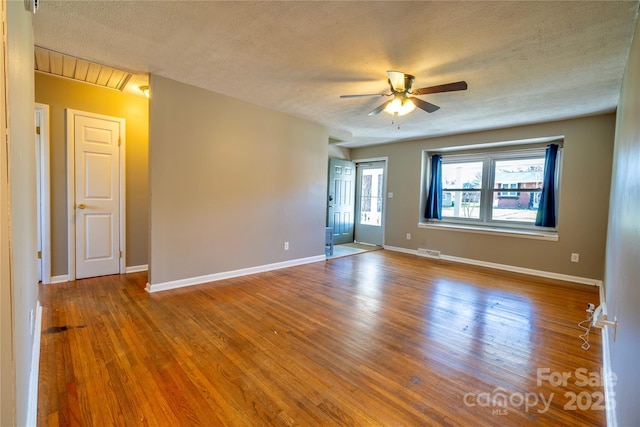 15 Oak Leaf Ln, Arden, NC 28704 - unfurnished room with ceiling fan, a textured ceiling, wood finished floors, baseboards, and attic access