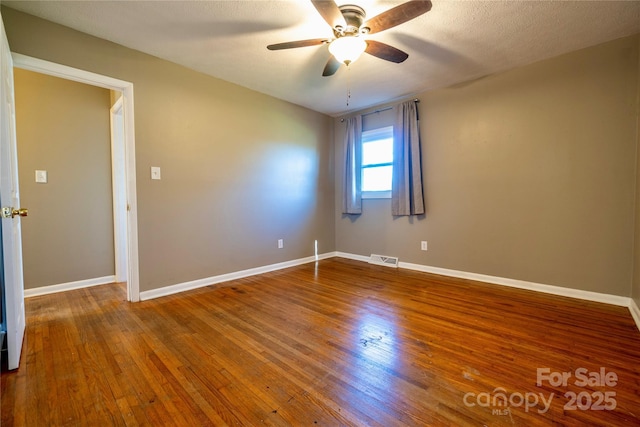 15 Oak Leaf Ln, Arden, NC 28704 - unfurnished room featuring a ceiling fan, wood finished floors, and baseboards
