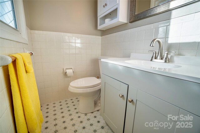 15 Oak Leaf Ln, Arden, NC 28704 - half bath featuring tile walls, vanity, toilet, and a wainscoted wall