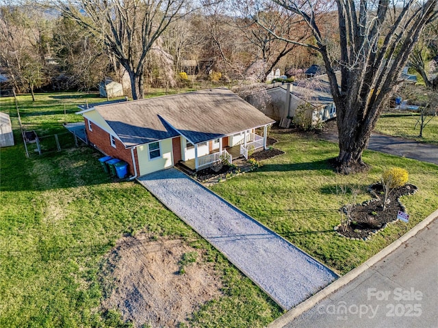 15 Oak Leaf Ln, Arden, NC 28704 - ranch-style home featuring gravel driveway, a porch, brick siding, and a front yard