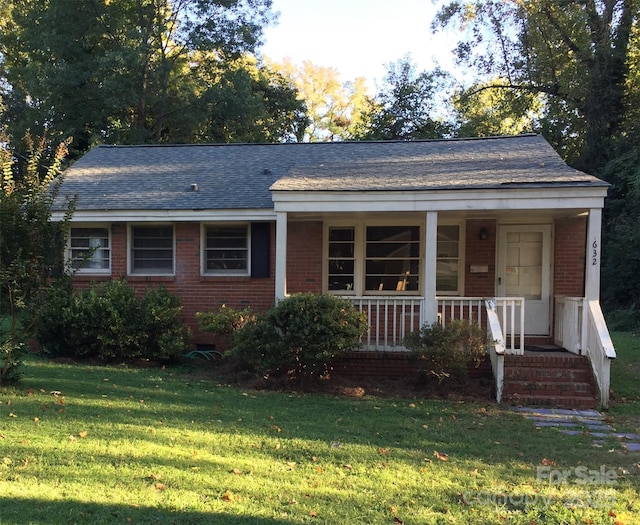 632 Fortune St, Charlotte, NC 28205 - view of front of property featuring brick siding, a front lawn, a shingled roof, and a porch