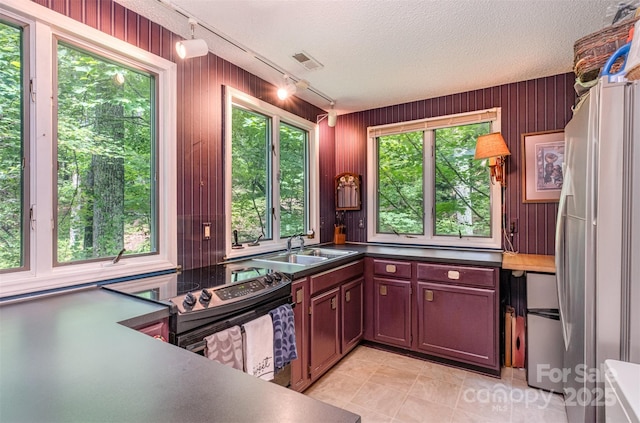 1102 Lake Montonia Rd, Kings Mountain, NC 28086 - kitchen with freestanding refrigerator, track lighting, a sink, electric range, and light tile patterned floors
