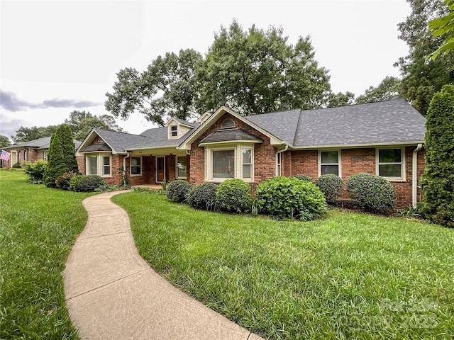 965 Hunting Ave, Lincolnton, NC 28092 - view of front of property featuring a front yard, brick siding, and roof with shingles