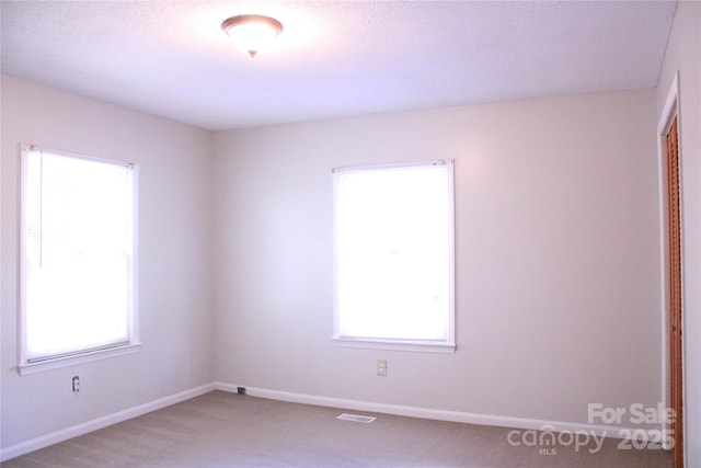 606 E 4th Ave, Gastonia, NC 28054 - spare room featuring carpet floors and baseboards