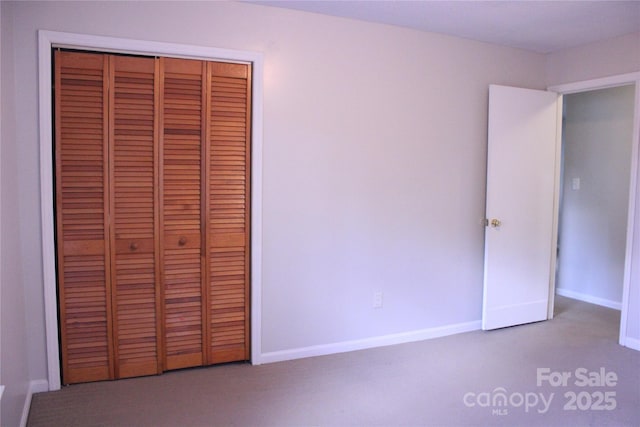 606 E 4th Ave, Gastonia, NC 28054 - unfurnished bedroom featuring a closet, baseboards, and carpet