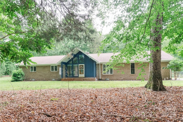 1565 Earnhardt Rd, Salisbury, NC 28146 - ranch-style house with brick siding, a sunroom, and a front yard