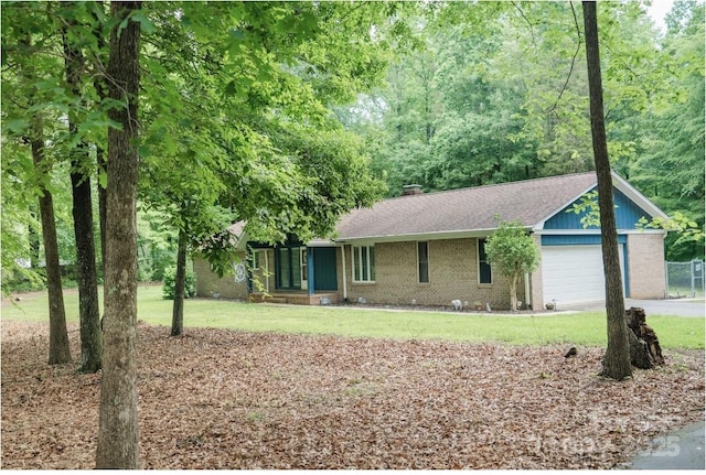 1565 Earnhardt Rd, Salisbury, NC 28146 - ranch-style home featuring an attached garage, brick siding, driveway, and a front yard