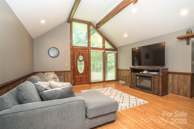 1565 Earnhardt Rd, Salisbury, NC 28146 - living area with wainscoting, beam ceiling, wood walls, wood finished floors, and a glass covered fireplace