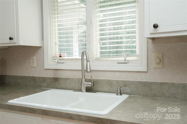 1565 Earnhardt Rd, Salisbury, NC 28146 - kitchen view of a sink and white cabinetry