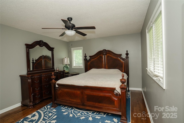 1565 Earnhardt Rd, Salisbury, NC 28146 - bedroom with dark wood-type flooring, baseboards, a textured ceiling, and a ceiling fan