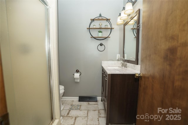 1565 Earnhardt Rd, Salisbury, NC 28146 - bathroom featuring vanity, a shower stall, toilet, and baseboards