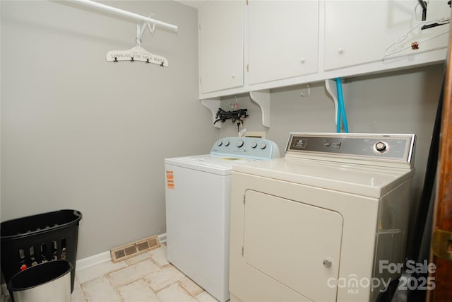 1565 Earnhardt Rd, Salisbury, NC 28146 - laundry area featuring washing machine and dryer, baseboards, and cabinet space