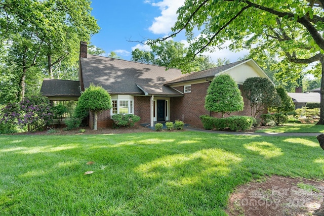 220 W Park Dr, Morganton, NC 28655 - view of front of house with brick siding, a front lawn, and a chimney