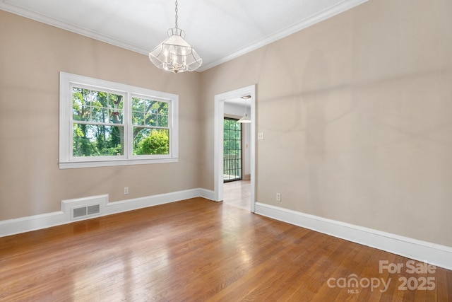220 W Park Dr, Morganton, NC 28655 - unfurnished room with a chandelier, ornamental molding, wood finished floors, and baseboards