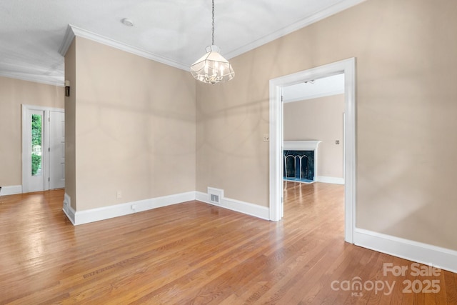 220 W Park Dr, Morganton, NC 28655 - unfurnished room featuring ornamental molding, light wood-style floors, a chandelier, baseboards, and a fireplace