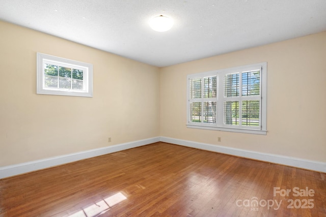 220 W Park Dr, Morganton, NC 28655 - empty room with healthy amount of natural light, baseboards, and wood finished floors