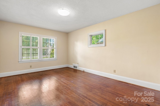 220 W Park Dr, Morganton, NC 28655 - unfurnished room featuring baseboards, wood-type flooring, and a textured ceiling