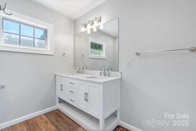 220 W Park Dr, Morganton, NC 28655 - bathroom featuring double vanity, baseboards, and wood finished floors