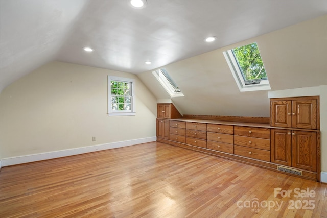 220 W Park Dr, Morganton, NC 28655 - additional living space with a skylight, light wood-type flooring, vaulted ceiling, recessed lighting, and baseboards