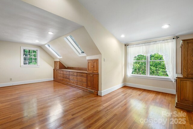 220 W Park Dr, Morganton, NC 28655 - additional living space featuring a skylight, light wood-style flooring, baseboards, vaulted ceiling, and recessed lighting