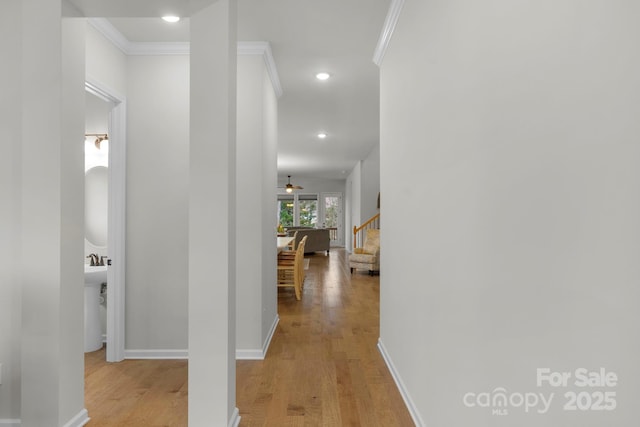 1124 Greenbridge Dr, Matthews, NC 28105 - hallway with light wood-style flooring, ornamental molding, stairway, baseboards, and recessed lighting