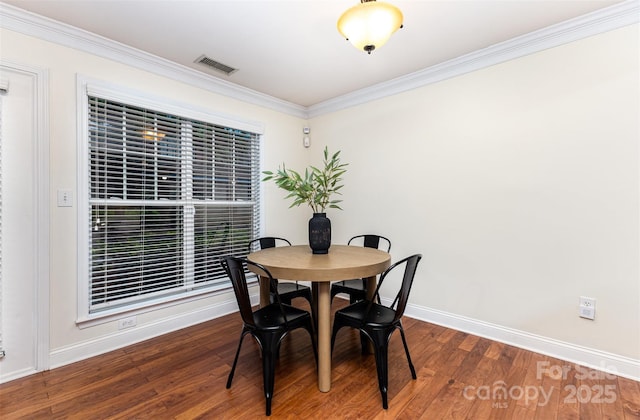1136 W 1st St, Charlotte, NC 28202 - dining space featuring baseboards, crown molding, and wood finished floors