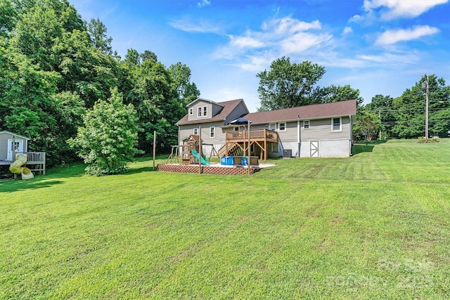 454 N Eastway Dr, Troutman, NC 28166 - view of grassy yard with a playground, a wooden deck, stairway, and central AC