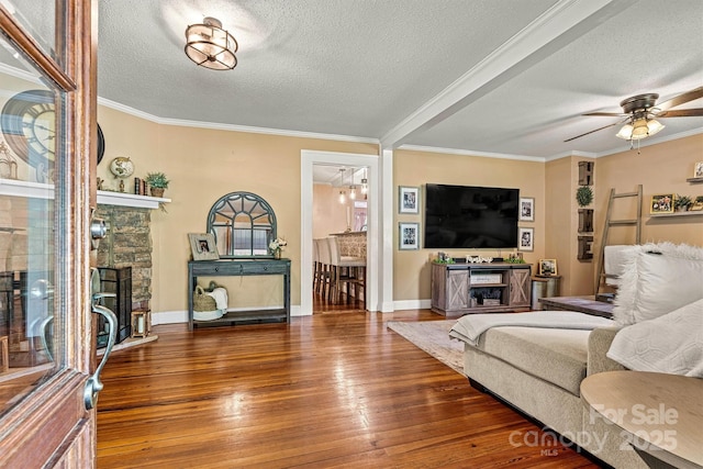 454 N Eastway Dr, Troutman, NC 28166 - living area featuring a fireplace, a textured ceiling, wood-type flooring, ceiling fan, and crown molding